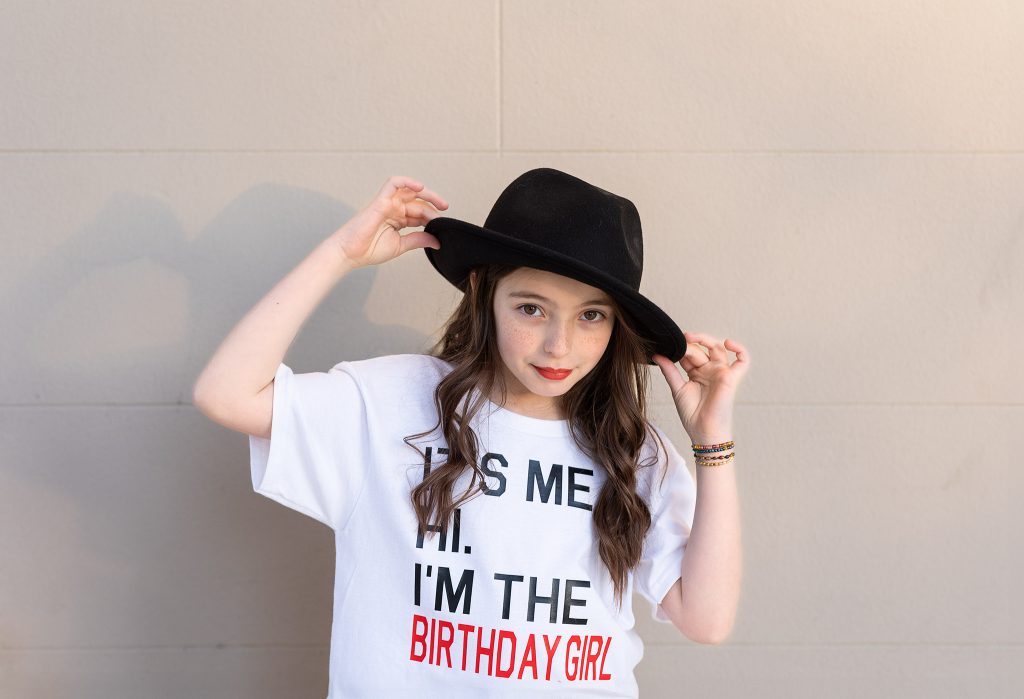 Nine-year-old girl in a Taylor Swift–inspired outfit posing confidently during her birthday photoshoot