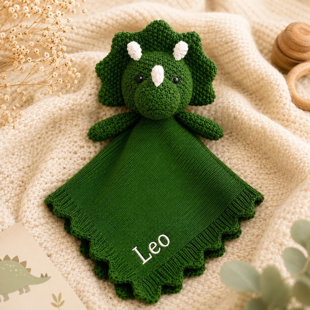 Knit triceratops lovey with a soft blanket body, personalized with baby's name