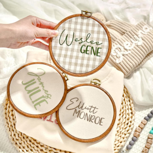 Baby's name embroidered on fabric and displayed in an embroidery hoop