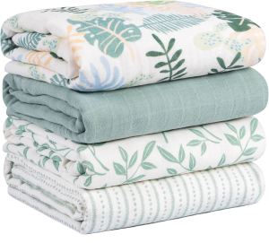 Muslin swaddle blankets in assorted green prints with tropical leaves