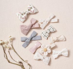 Set of bow headbands in assorted fabrics and shapes, including a flower headband