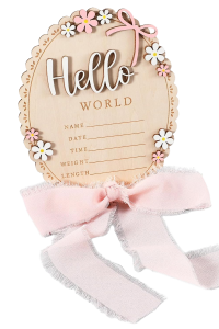 Oval wooden baby stats sign decorated with flowers and a chiffon bow