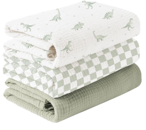 Muslin swaddle blankets in dinosaur print, checkered print, and solid sage